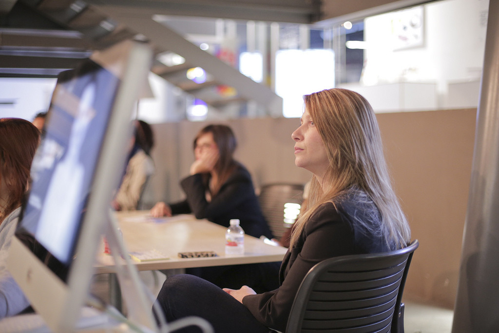 A woman listening intently in a meeting.