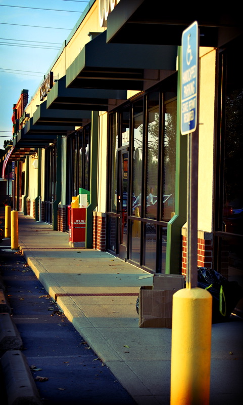 A strip mall with many stores side by side.