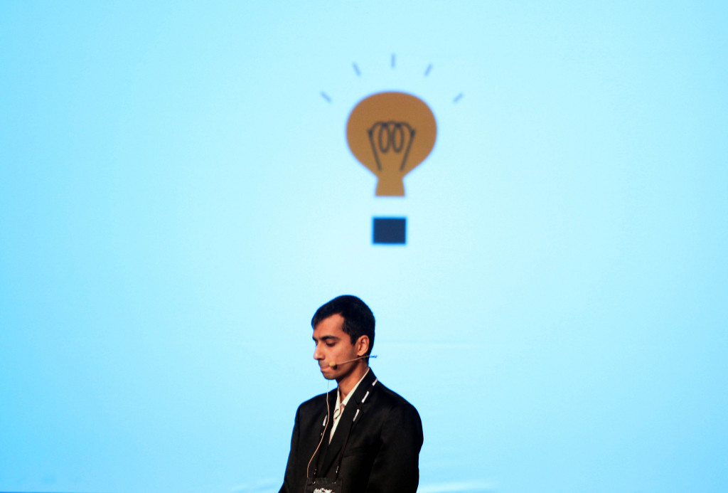 A man beneath a cartoon light bulb.