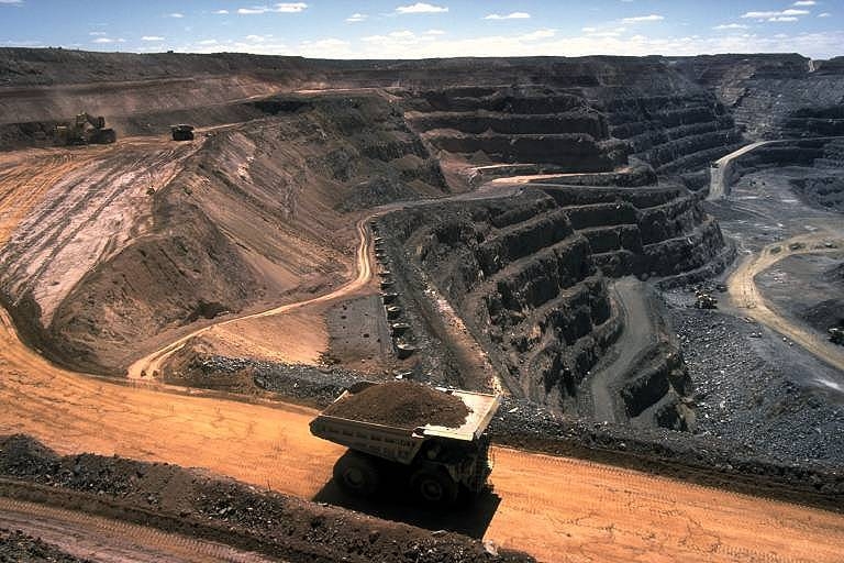 Truck filled with coal driving out of a coal mine.