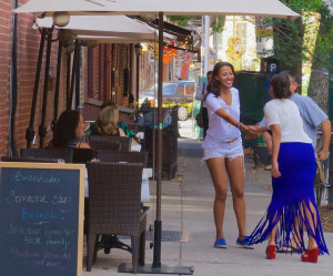 Women shaking hand on a city sidewalk