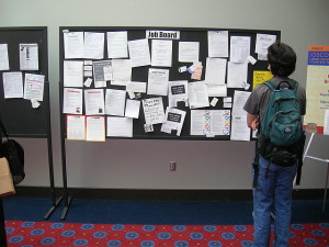Student standing in front of job bulletin board