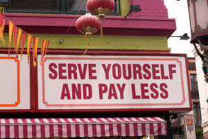 Sign reading "serve yourself and pay less"