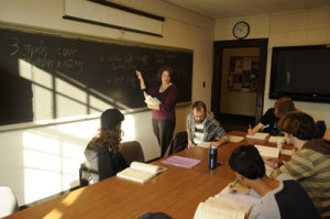Teacher in front of chalkboard