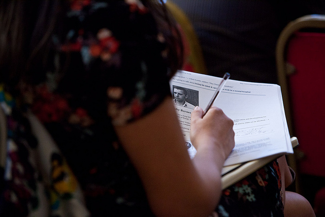 Arm of a woman taking notes in class