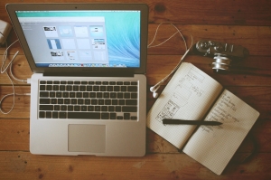 Computer on Desk with Notebook