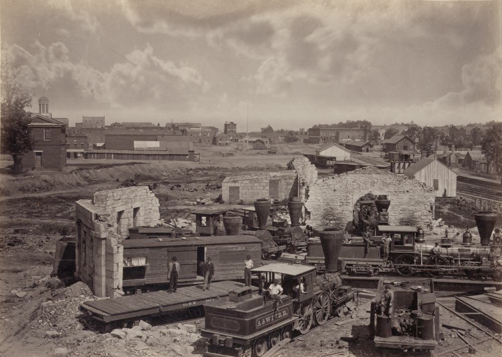 Black and white photograph of the city of Atlanta after the war, showing a destroyed railroad.