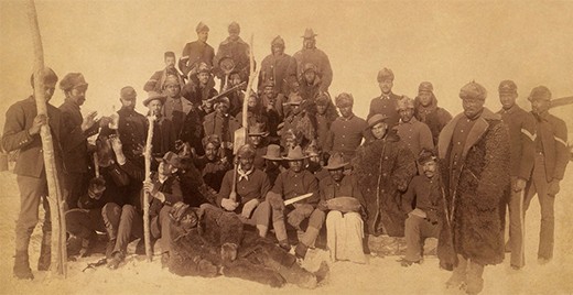 A photograph shows a posed group of uniformed 