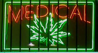 A photograph shows a window with a neon sign. The sign includes the word 