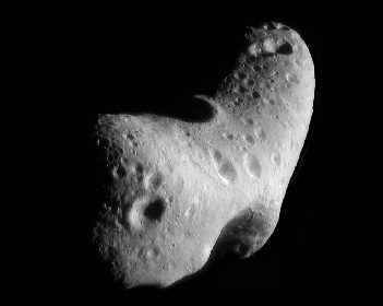 Image of the Asteroid Eros. Like nearly all asteroids, Eros is not spherical but very irregular in shape, in this case similar to a potato. The surface is pock-marked with many craters.