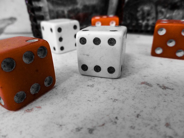 Five dice, red and white, on a marble surface