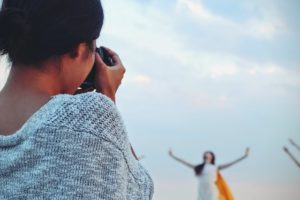 Photo shows a model posing in front of photographer.