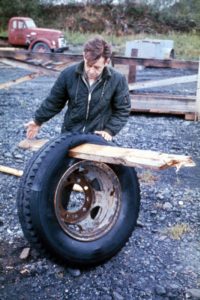 Image of A 2x6 plank driven through a ten-ply tire by the tsunami in Whittier.