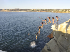 Cliff Jumping off a rock into the ocean.