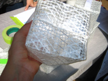 Photo of clear cube, the "Solar Puff," with white cross-hatching on all sides. Solar Puff is a solar-powered inflatable light that was designed to provide an affordable and renewable light source to disaster-relief victims.