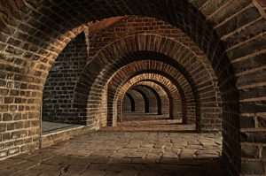 Series of brick archways at the base of a building.