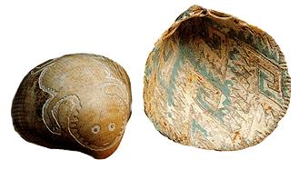 Image of the outside and inside of an etched shell. A creature with a face is etched on the outside, and intricate designs are etched on the inside.