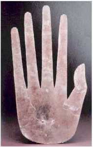 A sculpture of a hand with long, thin fingers.