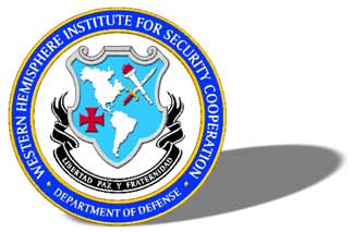 The logo includes the image of shield displaying a map of North and South America, a cross pattée, and a lit torch crossed with a sword. A ribbon with the words "Libertad Paz y Fraterndad," appears below the the shield. The shield and ribbons are surrounded by the name of the agency, "Western Hemisphere Institute for Security Cooperation" and "Department of Defense."