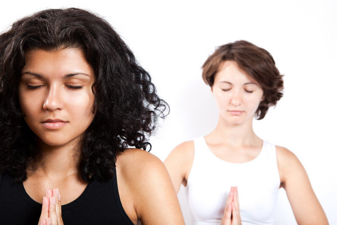 A picture of two women in a yoga pose.