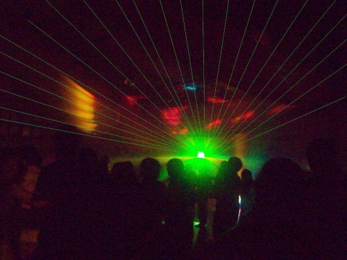 A picture of an audience at a laser show.