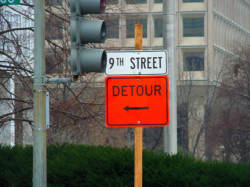A traffic detour sign