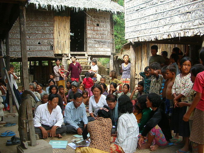An oral community in Takéo, Cambodia sits together and discusses a writing.
