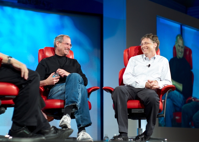 Photograph of Steve Jobs and Bill Gates sitting on a stage together.