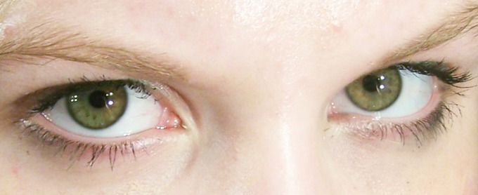 A woman makes direct eye contact.