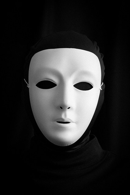 A picture of a person dressed in black spandex. All that's visible is a white face mask.