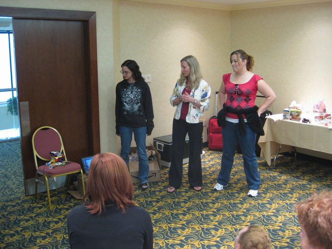 Three members of a group stand together and give a presentation.