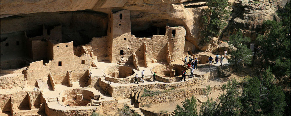 Photograph of Mesa Verde cliff dwellings, showing rooms built into the rocks and caves.