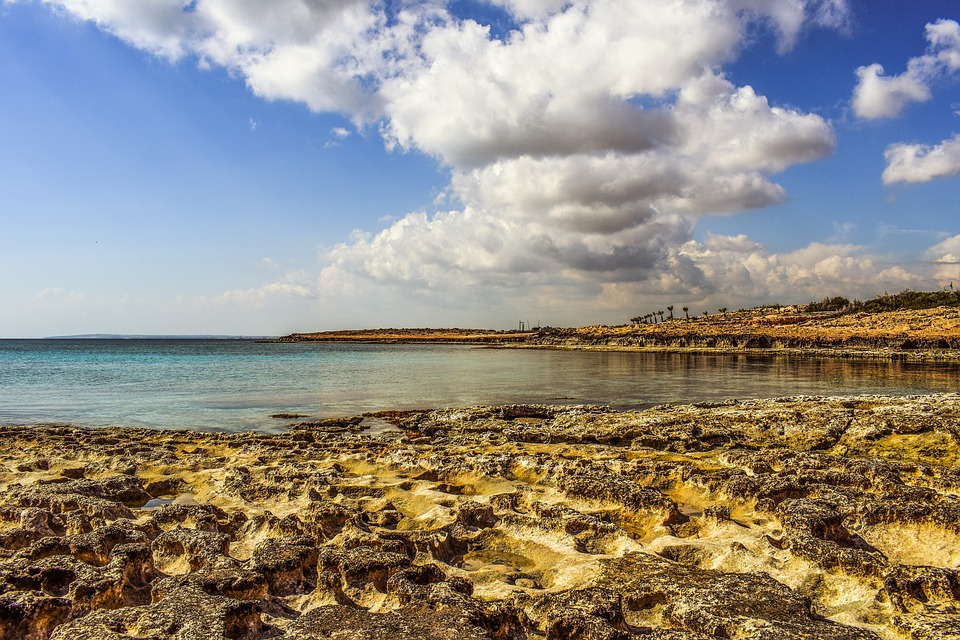 Clouds over a rocky beach and the ocean