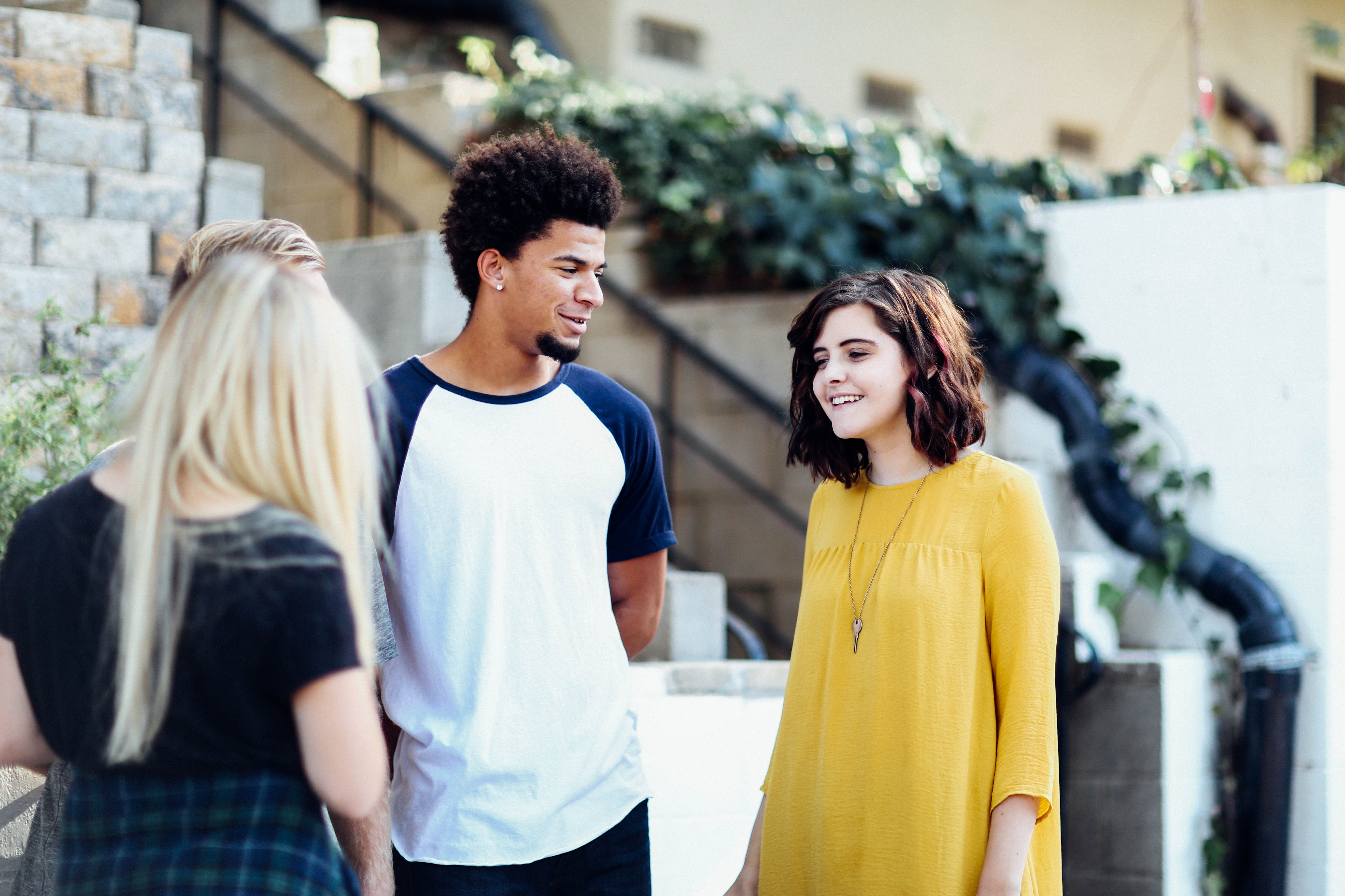 Four teenagers having a conversation.