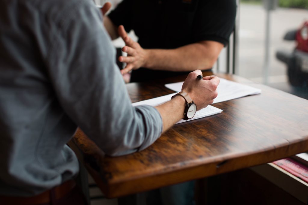 Photograph of two people sitting at a table. 