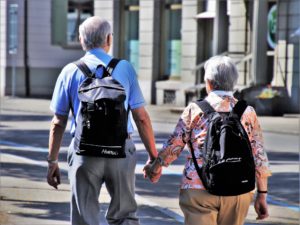 Senior couple holding hands.