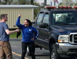 A woman yelling at a man in a parking lot.