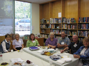 members of a book club sit around a table