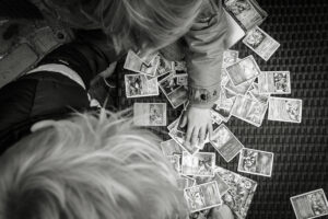 Overhead photograph of children sorting pokemon cards