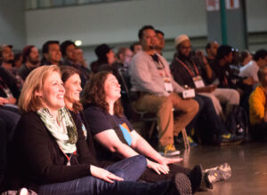 Audience members smiling