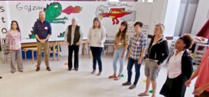 People standing in a circle in a classroom