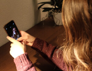 Young woman watching a recording of herself