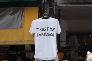 A handwritten T-shirt that says Trust Me I'm a Doctor