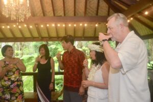 A woman making a toast while others prepare to drink