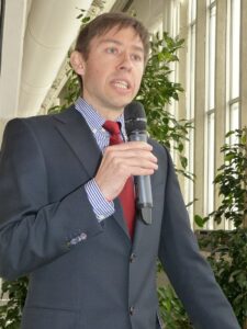 young man speaking into microphone