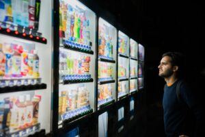 Man standing in front of large vending machine