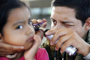 Doctor looking in a child's ear