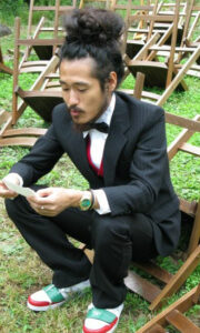 A man in a tuxedo reading notecards