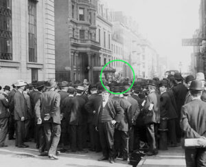 Old black and white photo of a speaker addressing a crowd