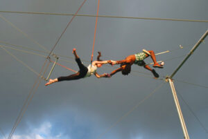 One trapeze artist catching another